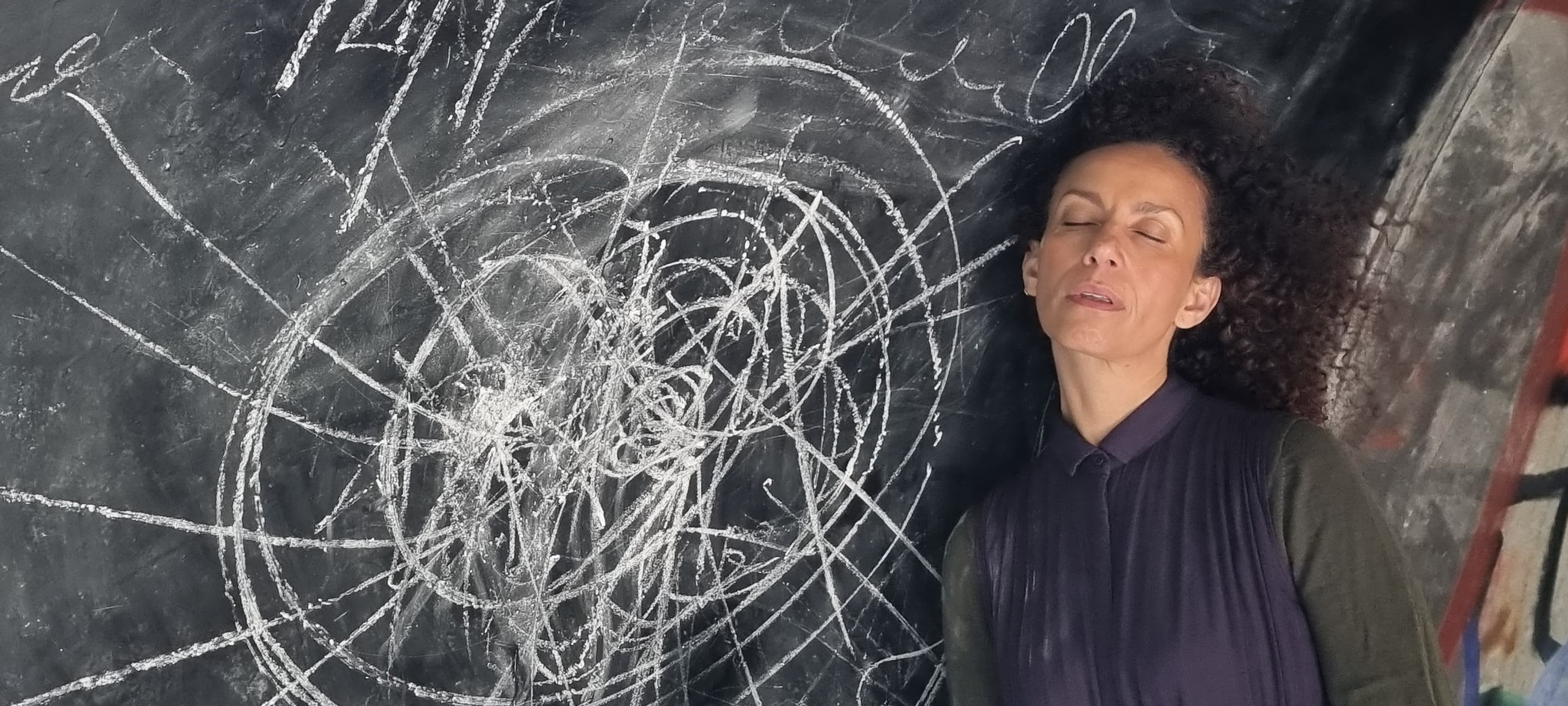 Charlotte Skak in front of a chalk drawing